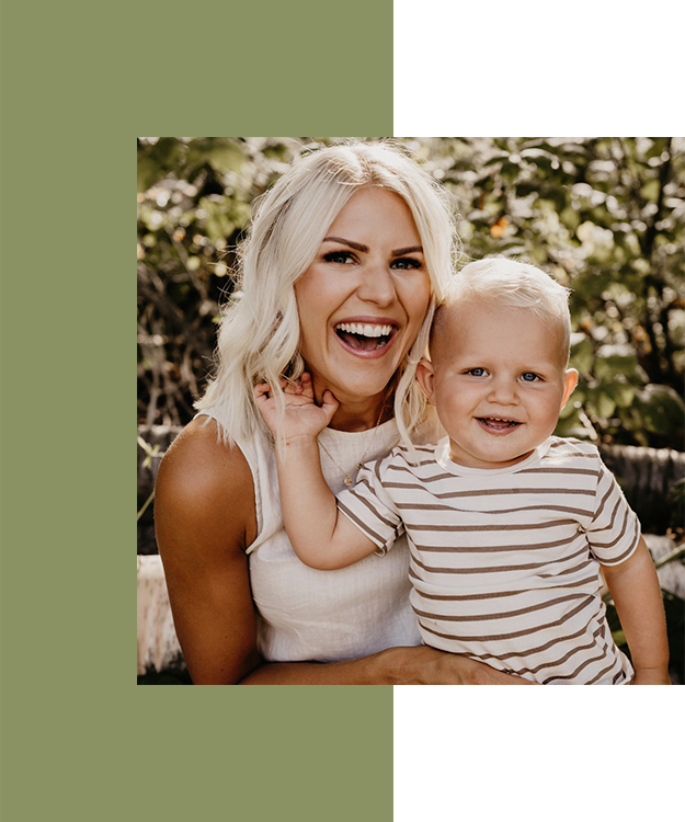 CFC intended parent, Angela, smiling and holding her son, Bauer, on her lap.